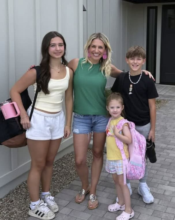 Happy family with children standing outside in casual clothes.