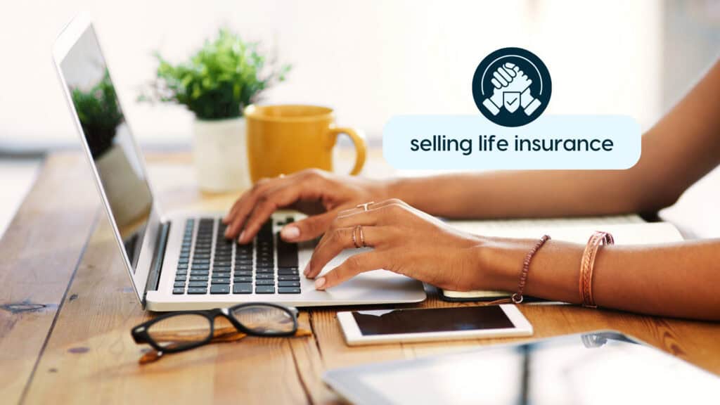 Person working on laptop with selling life insurance icon.