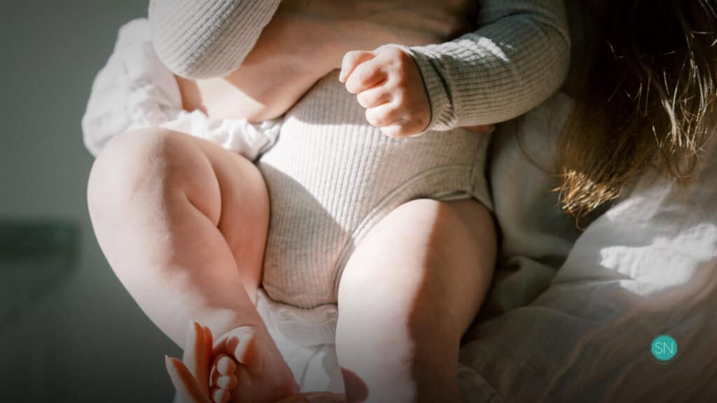 Mother holding her baby, emphasizing family and protection themes.